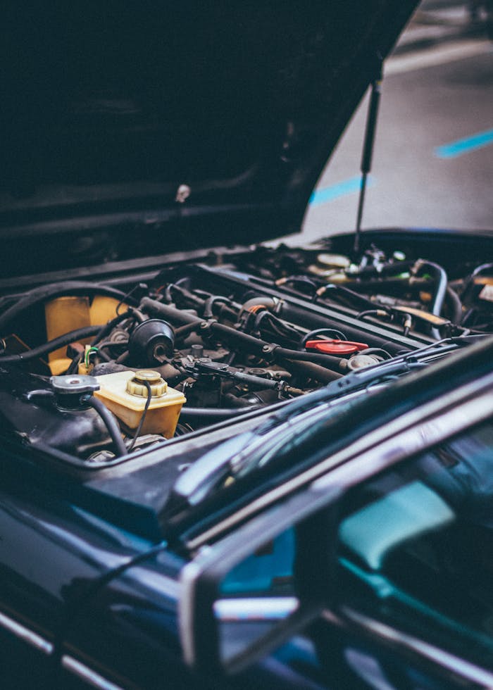 Services Detailed view of an exposed car engine under maintenance in Barcelona.